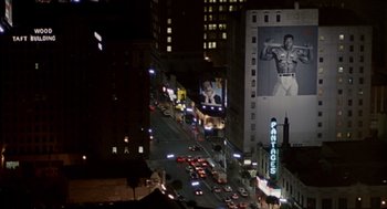 Movie still from “Pretty Woman” (1990), directed by Garry Marshall – A view of a city street at night with cars parked on the side of the street; Extreme Wide shot, Low angle