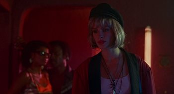 Movie still from “Pretty Woman” (1990), directed by Garry Marshall – A woman in a black hat and a red jacket; Close Up shot, Over the shoulder angle