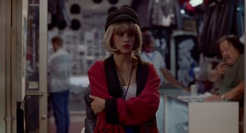 Movie still from “Pretty Woman” (1990), directed by Garry Marshall – A woman in a red jacket and black hat; Medium shot, High angle