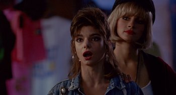 Movie still from “Pretty Woman” (1990), directed by Garry Marshall – A woman in a denim jacket and a woman in a black hat; Close Up shot, Over the shoulder angle