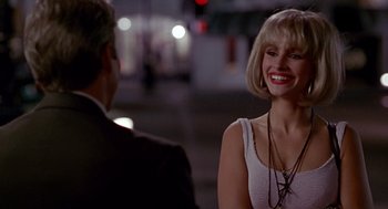 Movie still from “Pretty Woman” (1990), directed by Garry Marshall – A man and a woman smiling at each other; Close Up shot, Over the shoulder angle