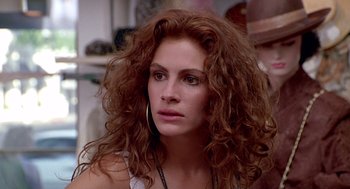 Movie still from “Pretty Woman” (1990), directed by Garry Marshall – A person with curly hair; Close Up shot, Over the shoulder angle