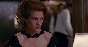 Movie still from “Pretty Woman” (1990), directed by Garry Marshall – A person wearing a black dress; Close Up shot, Over the shoulder angle