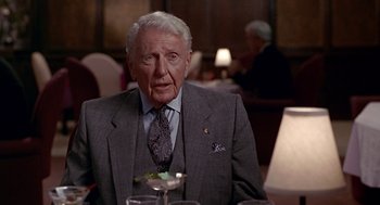 Movie still from “Pretty Woman” (1990), directed by Garry Marshall – An older man sitting at a dinner table; Close Up shot, Over the shoulder angle