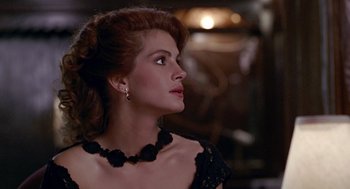 Movie still from “Pretty Woman” (1990), directed by Garry Marshall – A woman in a black dress looking to her left; Close Up shot, Over the shoulder angle