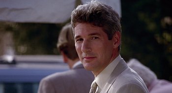 Movie still from “Pretty Woman” (1990), directed by Garry Marshall – A person wearing a suit and tie; Close Up shot, Over the shoulder angle