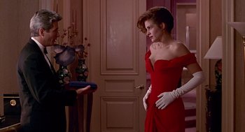 Movie still from “Pretty Woman” (1990), directed by Garry Marshall – A woman in a red dress and a man in white gloves; Medium shot, Over the shoulder angle