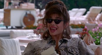 Movie still from “Pretty Woman” (1990), directed by Garry Marshall – A woman wearing sunglasses and a jean jacket; Medium shot, High angle