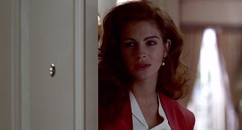 Movie still from “Pretty Woman” (1990), directed by Garry Marshall – A woman in a white shirt and a red jacket; Close Up shot, Over the shoulder angle