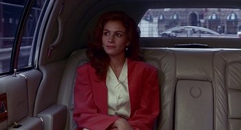 Movie still from “Pretty Woman” (1990), directed by Garry Marshall – A woman sitting in the back seat of a car; Medium shot, Over the shoulder angle