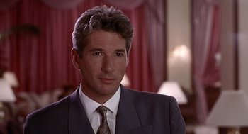 Movie still from “Pretty Woman” (1990), directed by Garry Marshall – A person wearing a suit and tie; Close Up shot, Over the shoulder angle