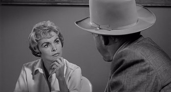 Movie still from “Psycho” (1960), directed by Alfred Hitchcock – An older woman sitting next to an older man in front of a mirror; Close Up shot, Over the shoulder angle