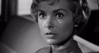 Movie still from “Psycho” (1960), directed by Alfred Hitchcock – A black - and - white photo of a woman's face; Close Up shot, Low angle