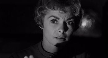 Movie still from “Psycho” (1960), directed by Alfred Hitchcock – An older woman with short blonde hair looking at the camera; Close Up shot, Low angle