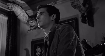 Movie still from “Psycho” (1960), directed by Alfred Hitchcock – Black and white photograph of a young man looking up; Close Up shot, Low angle