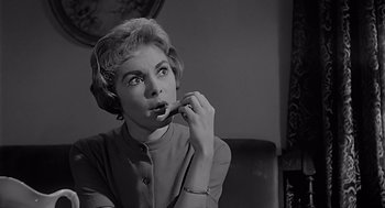 Movie still from “Psycho” (1960), directed by Alfred Hitchcock – An old photo of an older woman brushing her teeth; Close Up shot, Low angle