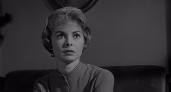 Movie still from “Psycho” (1960), directed by Alfred Hitchcock – A black - and - white photo of a woman looking at the camera; Close Up shot, Low angle