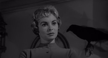 Movie still from “Psycho” (1960), directed by Alfred Hitchcock – A black and white photo of a woman with a bird flying above her head; Close Up shot, Low angle