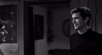 Movie still from “Psycho” (1960), directed by Alfred Hitchcock – Black and white photograph of a man in a room; Close Up shot, Over the shoulder angle