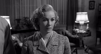 Movie still from “Psycho” (1960), directed by Alfred Hitchcock – An old photo of a woman in a suit looking to her left; Close Up shot, Low angle