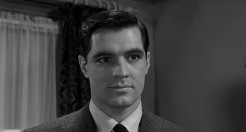Movie still from “Psycho” (1960), directed by Alfred Hitchcock – Black and white photograph of a man in a suit and tie; Close Up shot, Low angle