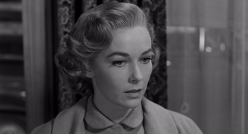 Movie still from “Psycho” (1960), directed by Alfred Hitchcock – An old photo of a woman in a suit looking to her left; Close Up shot, Low angle