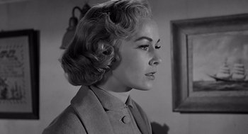 Movie still from “Psycho” (1960), directed by Alfred Hitchcock – A black and white photo of a woman in a suit; Close Up shot, Low angle