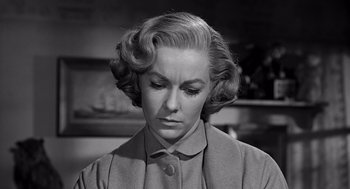 Movie still from “Psycho” (1960), directed by Alfred Hitchcock – An old photo of an older woman with a sad look on her face; Close Up shot, Low angle