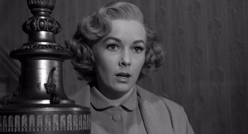 Movie still from “Psycho” (1960), directed by Alfred Hitchcock – An old photo of a woman in a suit; Close Up shot, Low angle