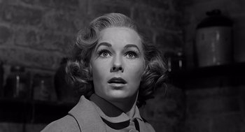 Movie still from “Psycho” (1960), directed by Alfred Hitchcock – An old photo of a woman looking up at the sky; Close Up shot, Low angle