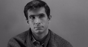 Movie still from “Psycho” (1960), directed by Alfred Hitchcock – Black and white photograph of a young man in a sweater; Close Up shot, High angle