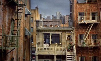 Movie still from “Rear Window” (1954), directed by Alfred Hitchcock – An old apartment building in the middle of a city; Extreme Wide shot, High angle