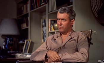 Movie still from “Rear Window” (1954), directed by Alfred Hitchcock – An older man sitting in front of a book shelf; Close Up shot, Over the shoulder angle