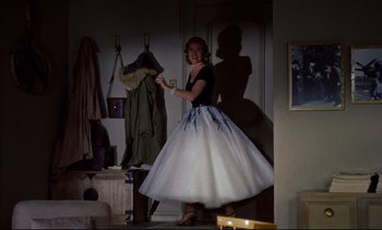 Movie still from “Rear Window” (1954), directed by Alfred Hitchcock – A woman in a black and white ball gown; Wide shot, High angle