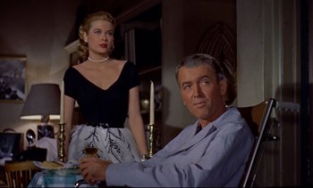 Movie still from “Rear Window” (1954), directed by Alfred Hitchcock – A man and a woman sitting at a dinner table; Medium shot, Low angle