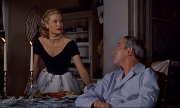 Movie still from “Rear Window” (1954), directed by Alfred Hitchcock – A man and a woman sitting at a dinner table; Medium shot, Over the shoulder angle