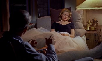 Movie still from “Rear Window” (1954), directed by Alfred Hitchcock – A man and a woman sitting on a bed; Medium shot, High angle