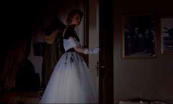 Movie still from “Rear Window” (1954), directed by Alfred Hitchcock – A woman in a white dress standing in front of a door; Wide shot, Low angle