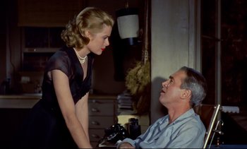 Movie still from “Rear Window” (1954), directed by Alfred Hitchcock – A man and a woman are talking in a room; Medium shot, Low angle