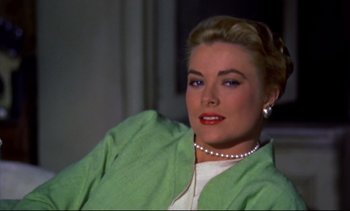 Movie still from “Rear Window” (1954), directed by Alfred Hitchcock – A woman in a white shirt and a green jacket; Close Up shot, Over the shoulder angle