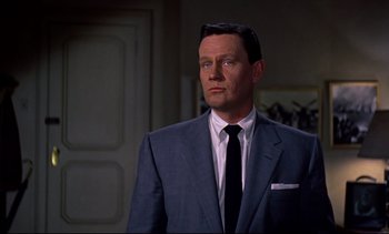 Movie still from “Rear Window” (1954), directed by Alfred Hitchcock – A person wearing a suit and tie; Close Up shot, High angle
