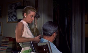 Movie still from “Rear Window” (1954), directed by Alfred Hitchcock – A woman cutting a mans hair in a barber shop; Medium shot, Over the shoulder angle