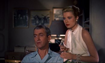 Movie still from “Rear Window” (1954), directed by Alfred Hitchcock – A man and a woman are standing in a living room; Close Up shot, Over the shoulder angle