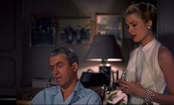 Movie still from “Rear Window” (1954), directed by Alfred Hitchcock – An older man sitting next to an older woman; Medium shot, Low angle