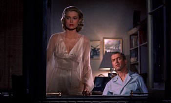 Movie still from “Rear Window” (1954), directed by Alfred Hitchcock – A man and a woman standing in front of a mirror; Medium shot, Low angle