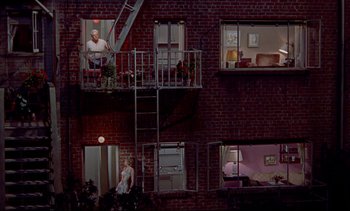Movie still from “Rear Window” (1954), directed by Alfred Hitchcock – A man standing on a fire escape of a building; Extreme Wide shot, Overhead angle