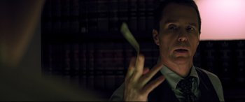 Movie still from “Richard Jewell” (2019), directed by Clint Eastwood – A man in a suit holding a banana in his hand; Close Up shot, Low angle