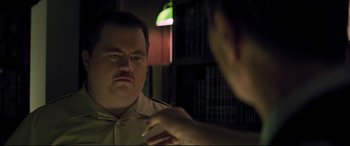 Movie still from “Richard Jewell” (2019), directed by Clint Eastwood – A man looking at his reflection in a mirror; Close Up shot, Over the shoulder angle