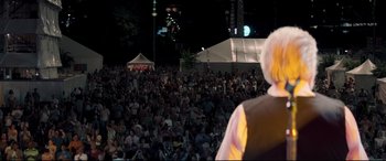 Movie still from “Richard Jewell” (2019), directed by Clint Eastwood – A crowd of people sitting in front of a white tent; Medium shot, Over the shoulder angle