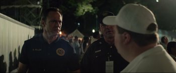 Movie still from “Richard Jewell” (2019), directed by Clint Eastwood – A group of men standing next to each other on a field; Close Up shot, Over the shoulder angle